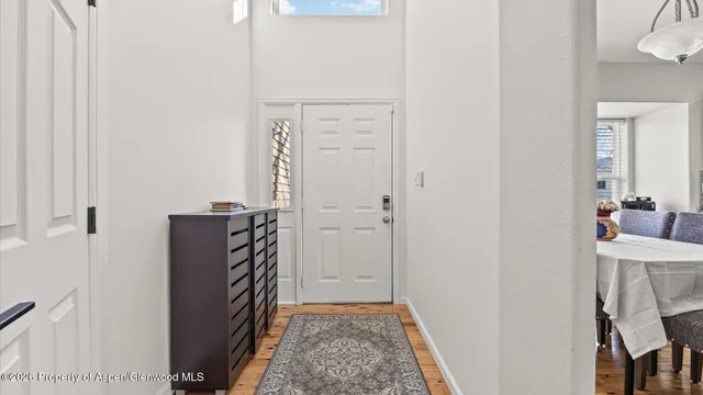 a view of a hallway with closet and wooden floor