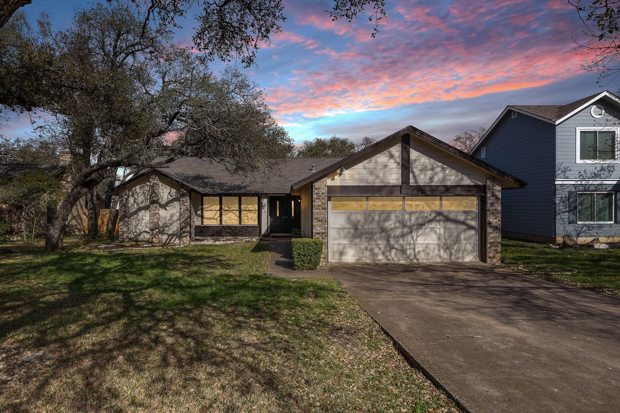 This home has incredible curb appeal with its gorgeous mature live oaks. The fact that his has a converted garage is cleverly disguised by the garage door.