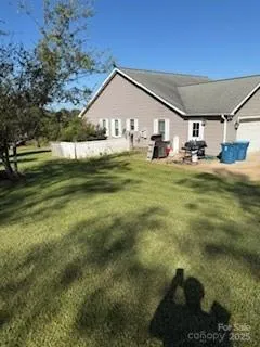 a view of room with wooden floor and ceiling fan