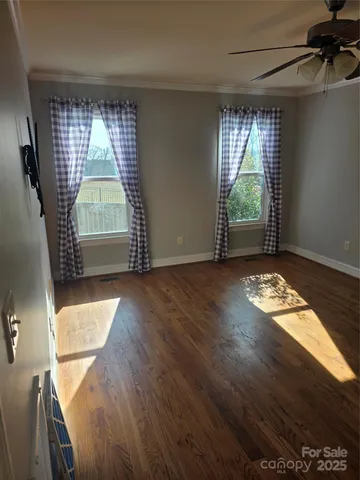 a view of room with window and wooden floor