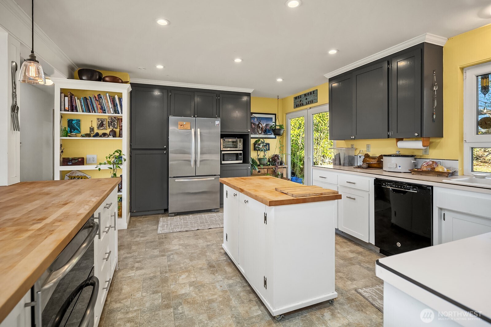 856 Stetson Avenue Kent, WA 98031 - Photo 14 of 39 a kitchen with a refrigerator a sink and wooden cabinets