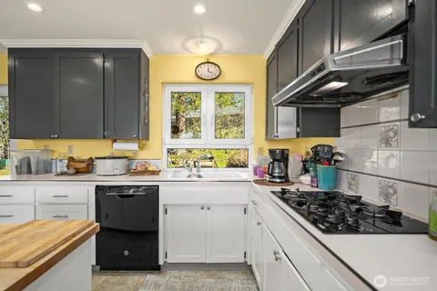 a kitchen with stainless steel appliances a sink a stove and cabinets