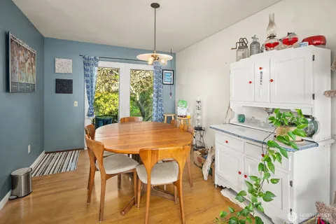 a view of a dining room with furniture window and wooden floor