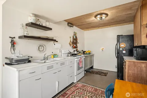 a kitchen with a sink a stove and cabinets