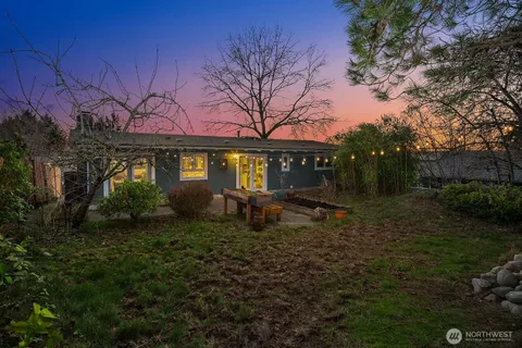 a backyard of a house with yard and outdoor seating