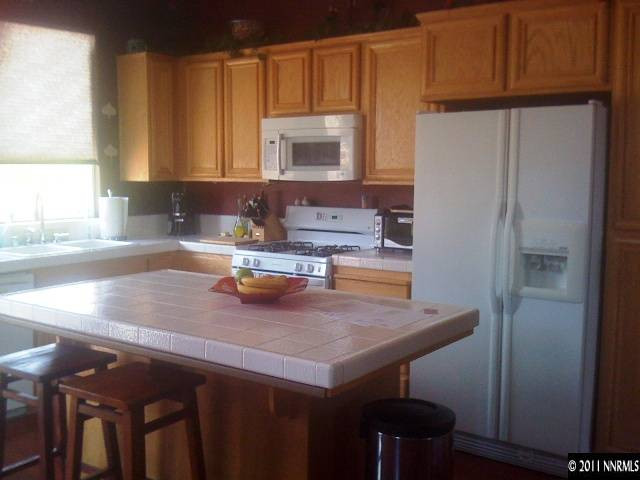 2799 Newburgh Way Reno, NV 89523 - Photo 2 of 9 a kitchen with a sink a microwave and cabinets