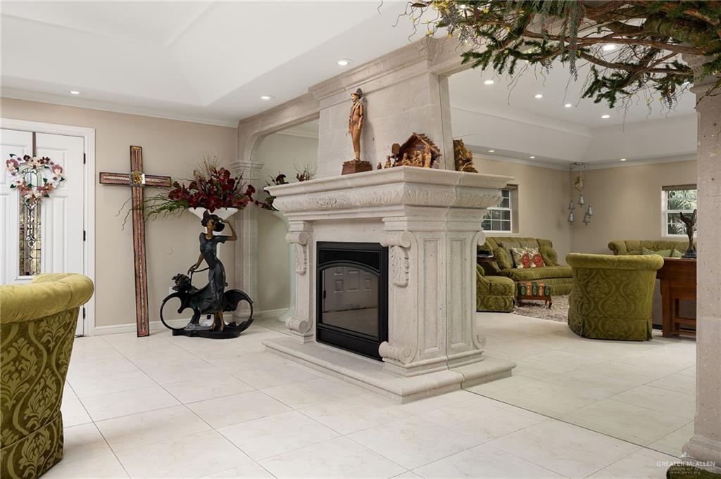 301 Vermont Avenue McAllen, TX 78503 - Photo 6 of 25 a living room with furniture a fireplace and white walls