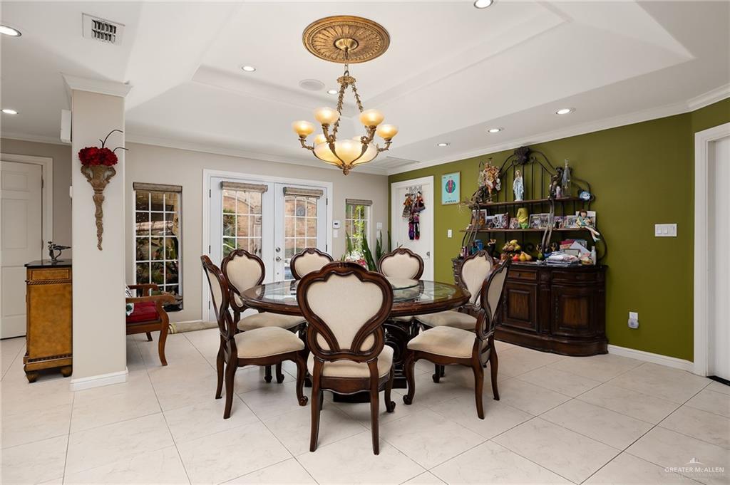 301 Vermont Avenue McAllen, TX 78503 - Photo 8 of 25 a view of a dining room with furniture and chandelier