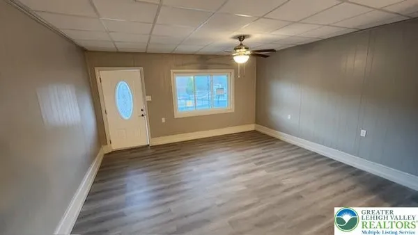 a view of a hallway with wooden floor and staircase