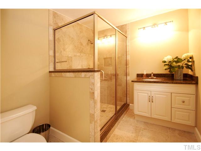 7900 Farmingwood Lane Raleigh, NC 27615 - Photo 11 of 25 a bathroom with a sink a toilet and shower