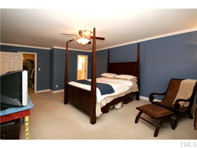 7900 Farmingwood Lane Raleigh, NC 27615 - Photo 13 of 25 a bedroom with a bed chair and the view of living room