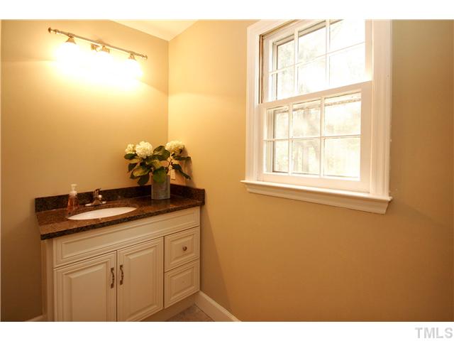 7900 Farmingwood Lane Raleigh, NC 27615 - Photo 20 of 25 a bathroom with a granite countertop sink and a mirror