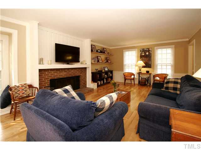 7900 Farmingwood Lane Raleigh, NC 27615 - Photo 4 of 25 a living room with furniture fireplace and flat screen tv