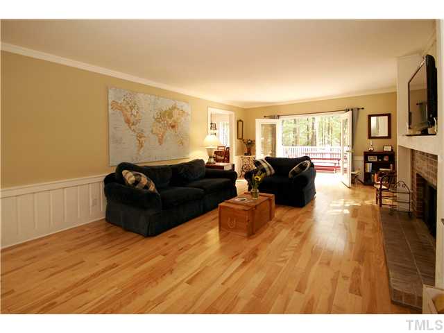 7900 Farmingwood Lane Raleigh, NC 27615 - Photo 10 of 25 a living room with furniture flat screen tv and wooden floor