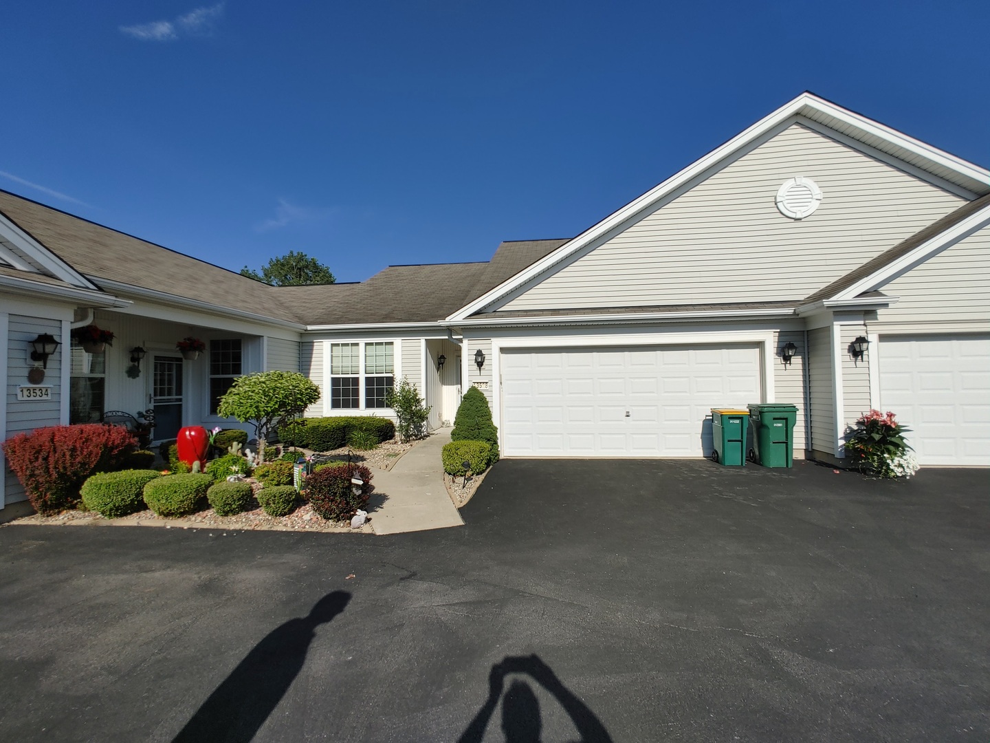 13528 Delaney Road Huntley, IL 60142 - Photo 1 of 25 a front view of a house with a garden and porch