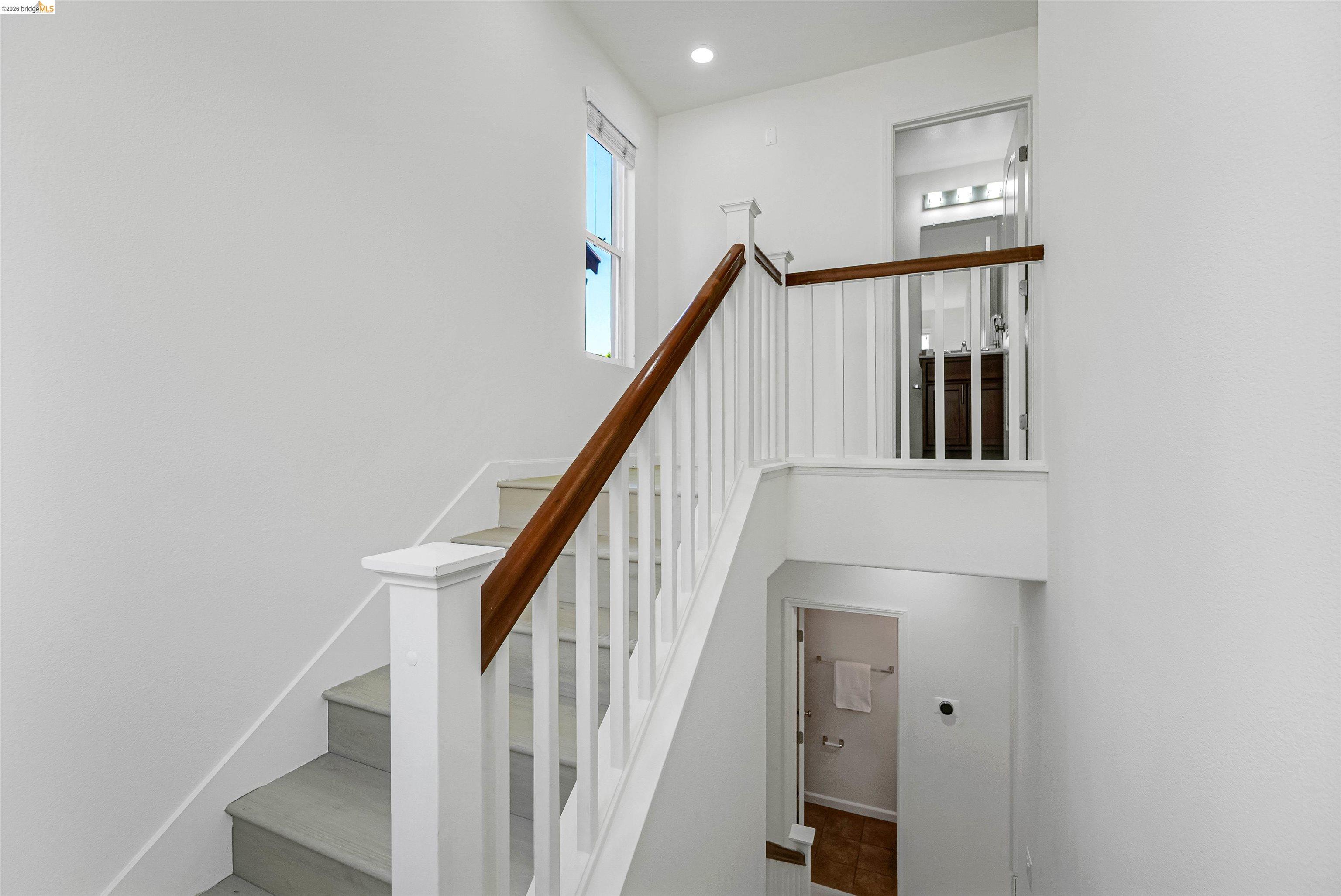 449 Constantine Court San Ramon, CA 94583 - Photo 35 of 63 Staircase featuring white risers, light-toned treads, and a banister with white balusters and a wood-finish handrail