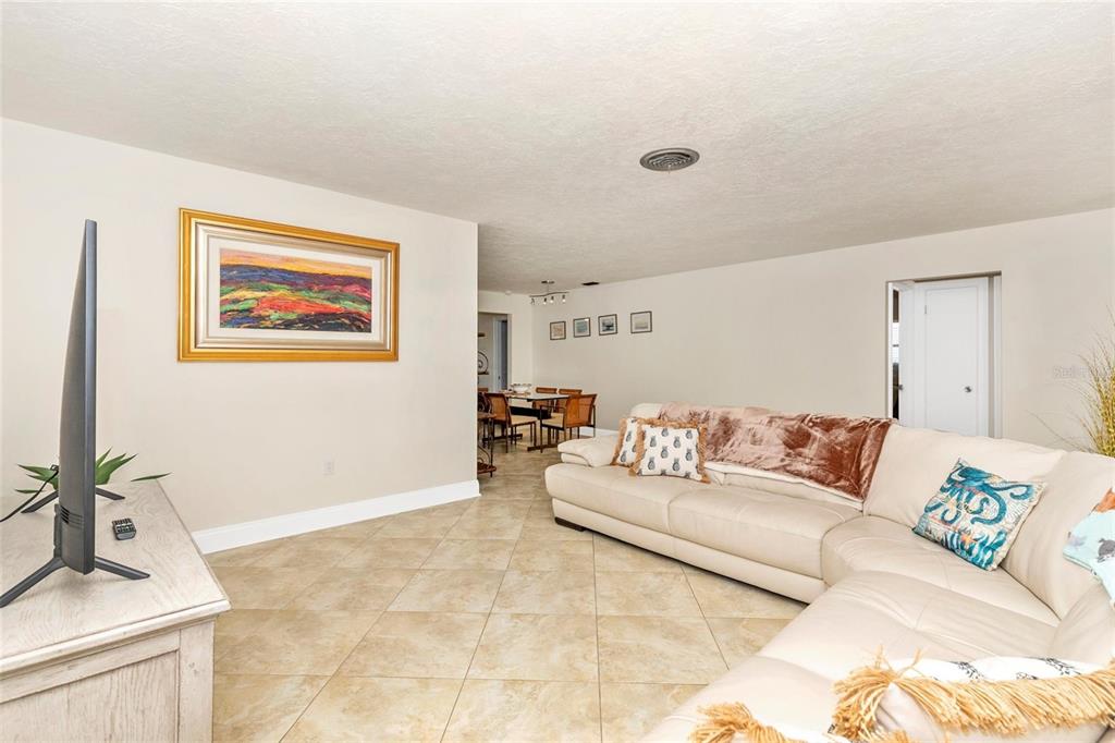 3039 Chase Circle Sarasota, FL 34231 - Photo 11 of 55 a living room with furniture and a potted plant