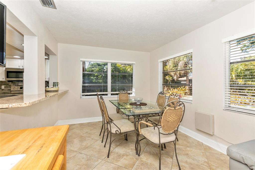 3039 Chase Circle Sarasota, FL 34231 - Photo 18 of 55 a view of a dining room with furniture and a potted plant