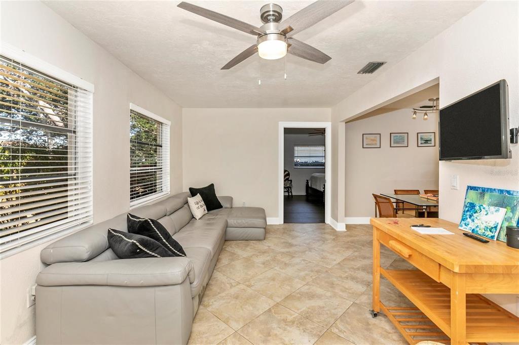 3039 Chase Circle Sarasota, FL 34231 - Photo 20 of 55 a living room with furniture and a flat screen tv