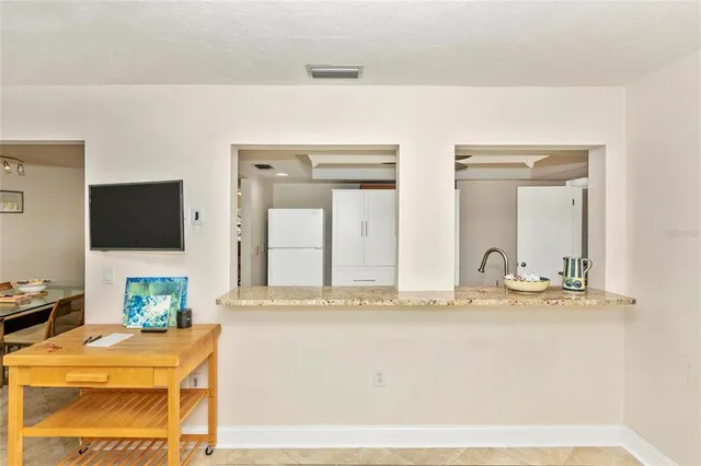 a kitchen with granite countertop a stove top oven and cabinets