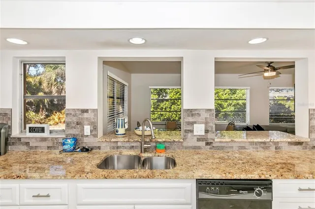 a kitchen with a refrigerator stove and white cabinets