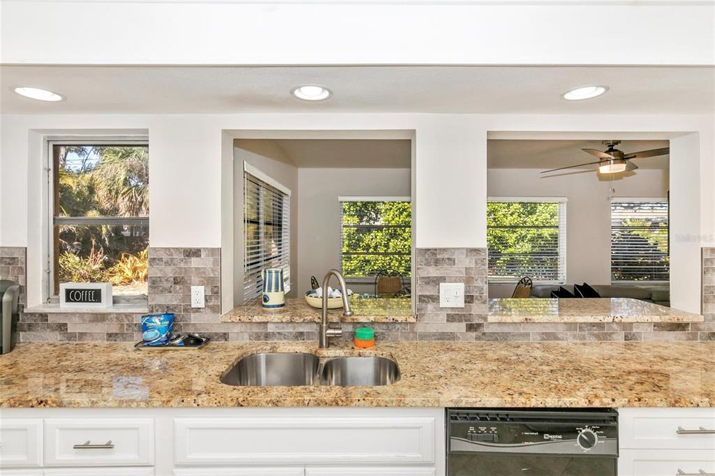 3039 Chase Circle Sarasota, FL 34231 - Photo 27 of 55 a kitchen with granite countertop a sink and a counter top space