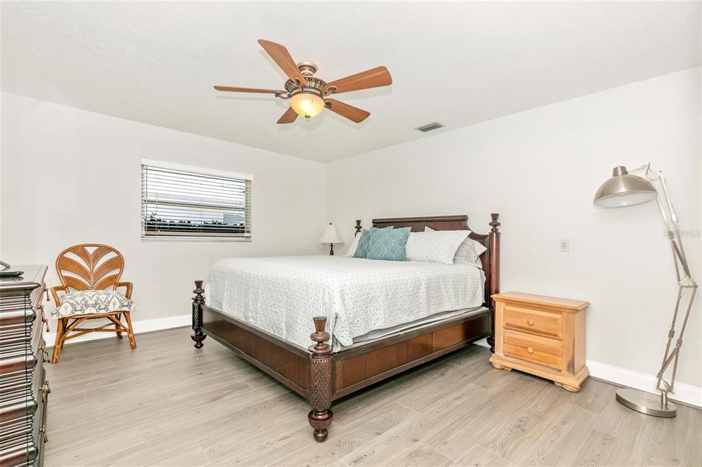 3039 Chase Circle Sarasota, FL 34231 - Photo 30 of 55 a bed room with a bed and painting on the wall