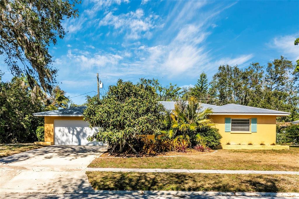 3039 Chase Circle Sarasota, FL 34231 - Photo 3 of 55 a front view of a house with a yard