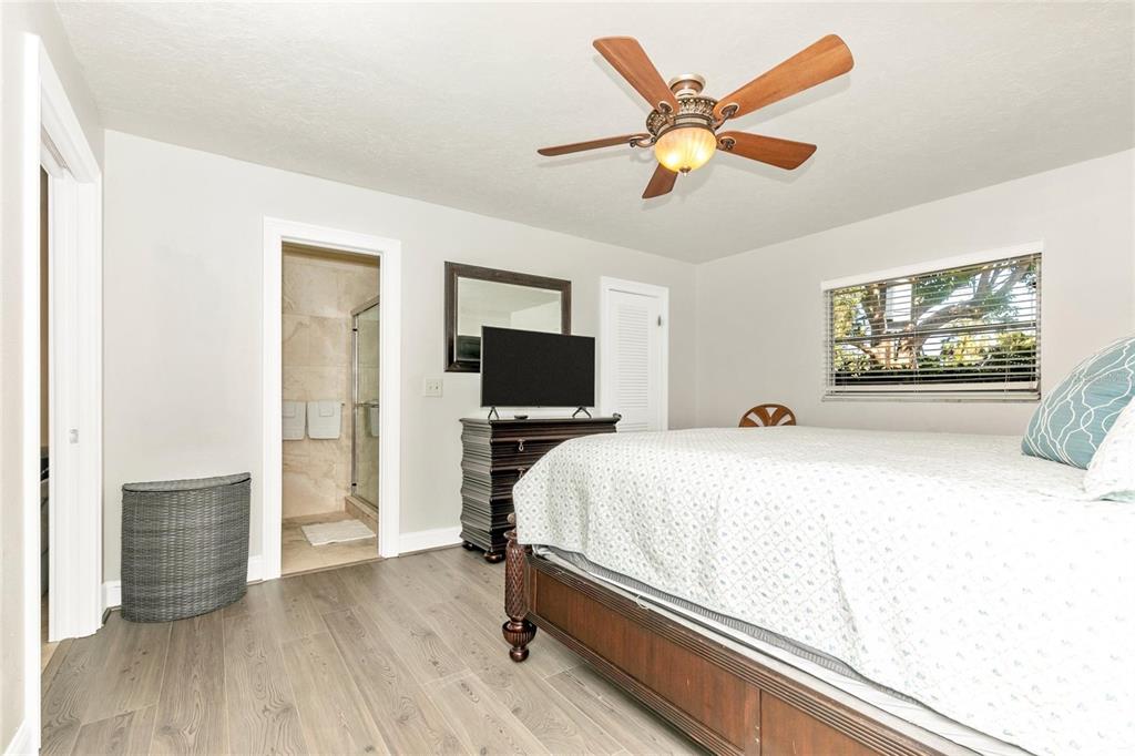 3039 Chase Circle Sarasota, FL 34231 - Photo 31 of 55 a bedroom with a bed and a flat screen tv