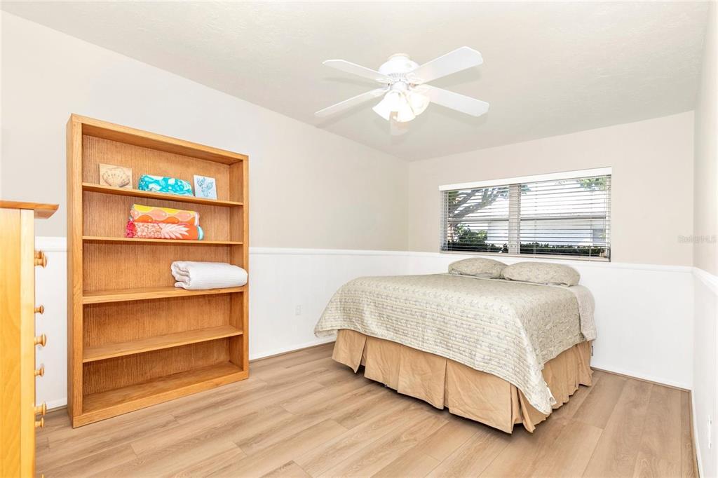 3039 Chase Circle Sarasota, FL 34231 - Photo 34 of 55 a bedroom with a bed and a bookshelf