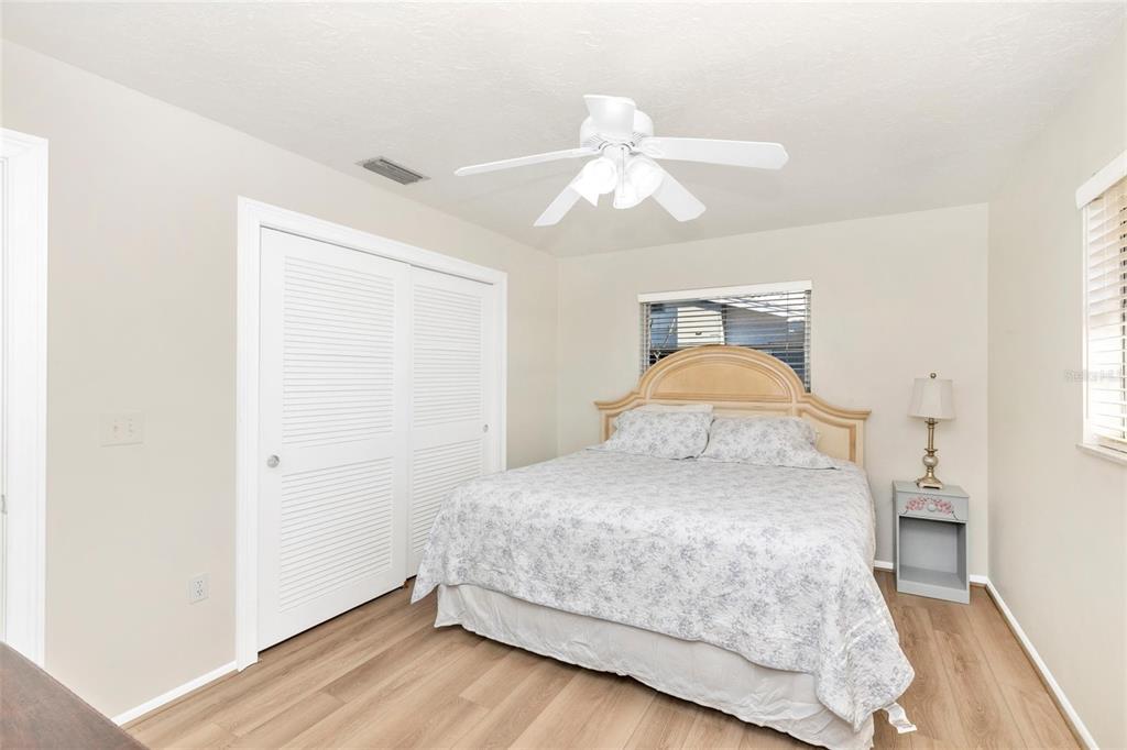 3039 Chase Circle Sarasota, FL 34231 - Photo 36 of 55 a bedroom with a bed and wooden floor