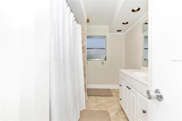 a bathroom with a bathtub sink and mirror