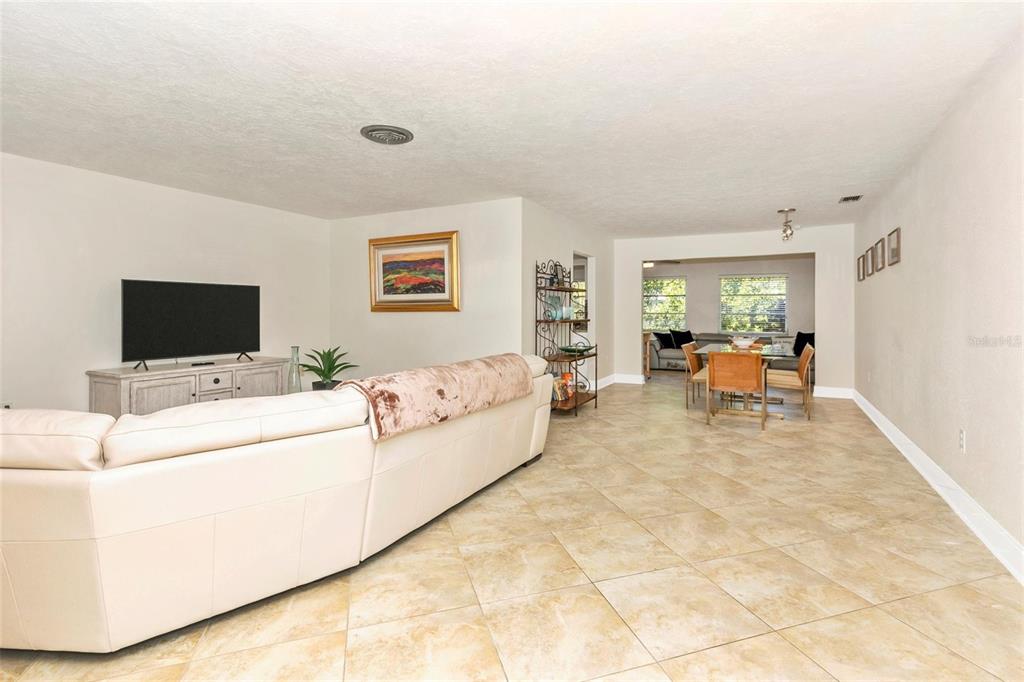 3039 Chase Circle Sarasota, FL 34231 - Photo 6 of 55 a living room with furniture and a flat screen tv