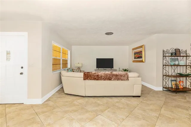 a dining room with furniture and a window