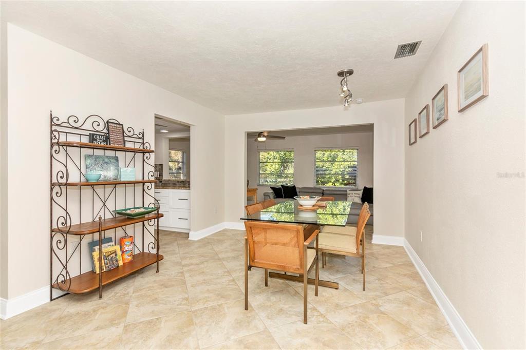 3039 Chase Circle Sarasota, FL 34231 - Photo 9 of 55 a dining room with furniture and a window