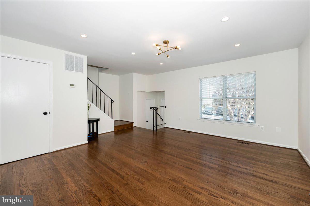 12144 Turnstone Court, Unit 87 Silver Spring, MD 20904 - Photo 18 of 56 a view of an empty room with wooden floor and a window