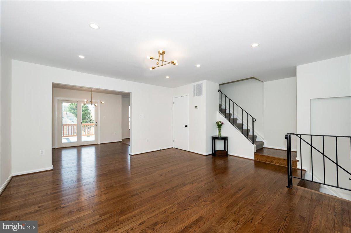 12144 Turnstone Court, Unit 87 Silver Spring, MD 20904 - Photo 19 of 56 a view of an empty room with wooden floor and a window