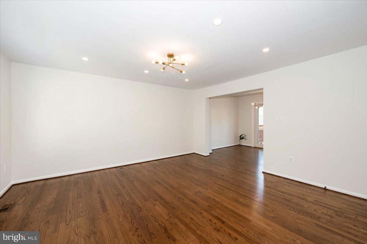 12144 Turnstone Court, Unit 87 Silver Spring, MD 20904 - Photo 20 of 56 a view of an empty room with wooden floor and a chandelier