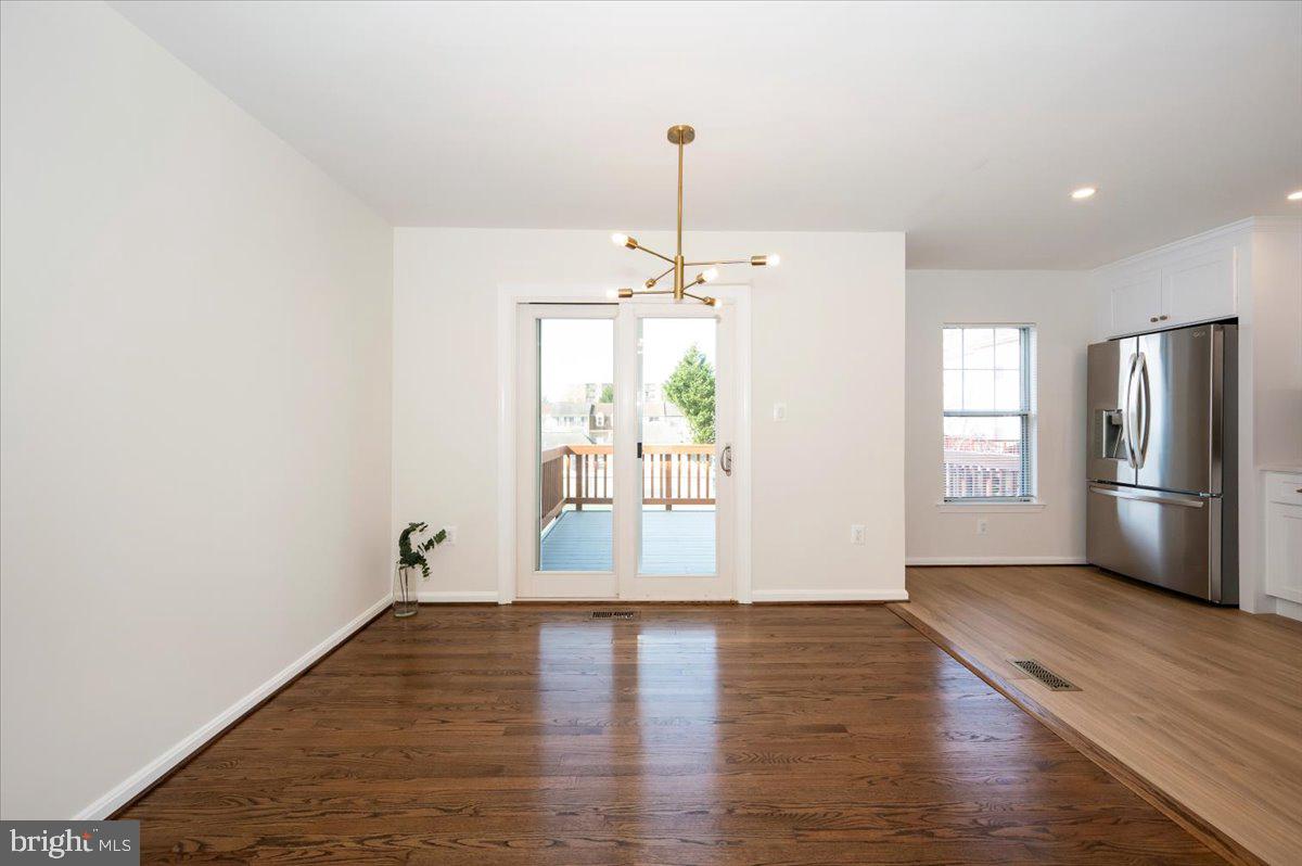 12144 Turnstone Court, Unit 87 Silver Spring, MD 20904 - Photo 21 of 56 a view of an empty room with window and wooden floor