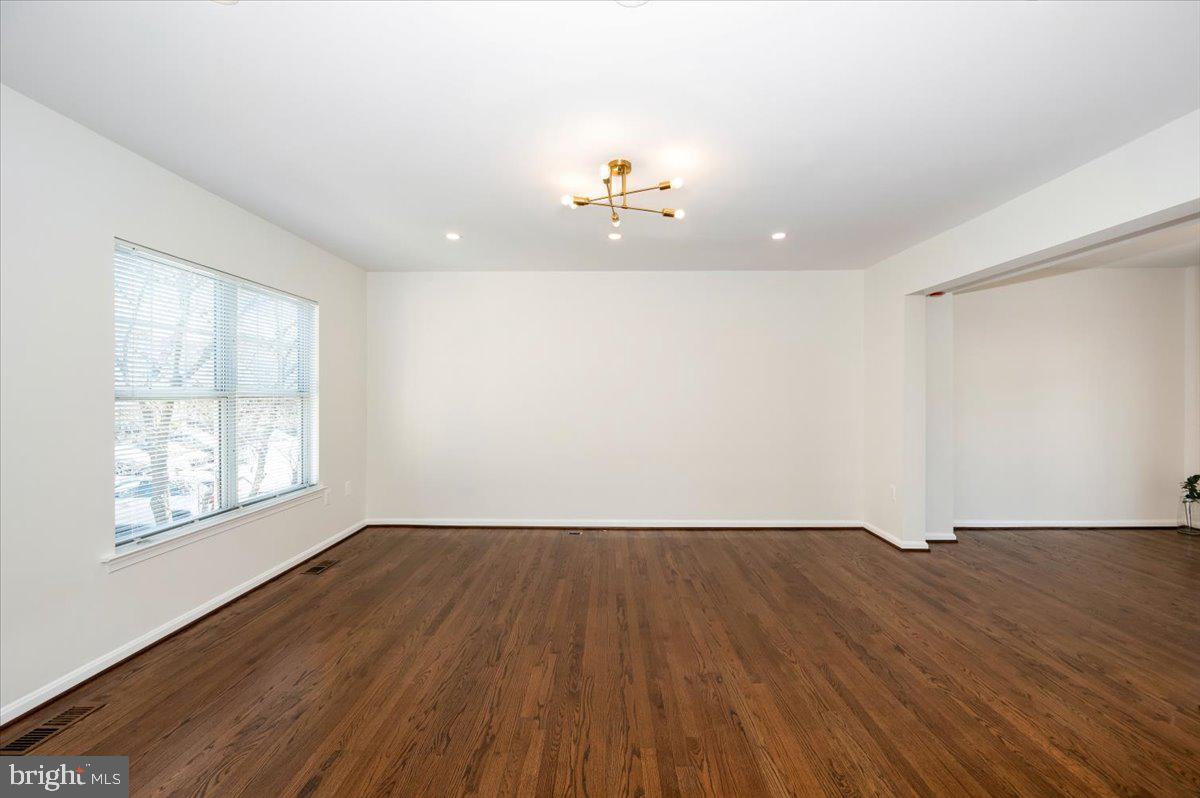 12144 Turnstone Court, Unit 87 Silver Spring, MD 20904 - Photo 23 of 56 an empty room with wooden floor and windows