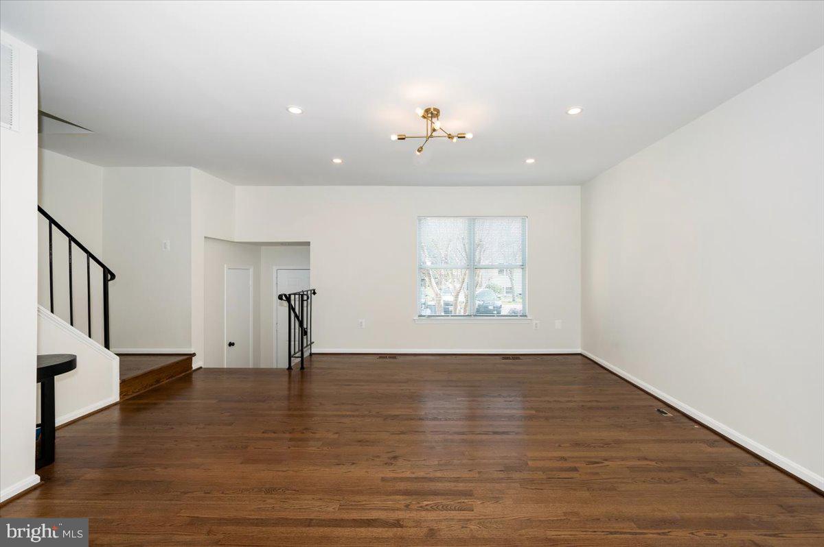 12144 Turnstone Court, Unit 87 Silver Spring, MD 20904 - Photo 26 of 56 a view of an empty room with a window and wooden floor