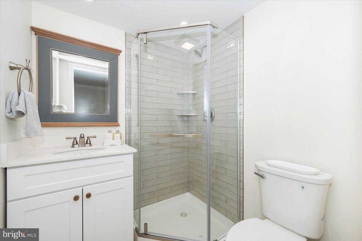12144 Turnstone Court, Unit 87 Silver Spring, MD 20904 - Photo 29 of 56 a bathroom with a sink mirror toilet and shower