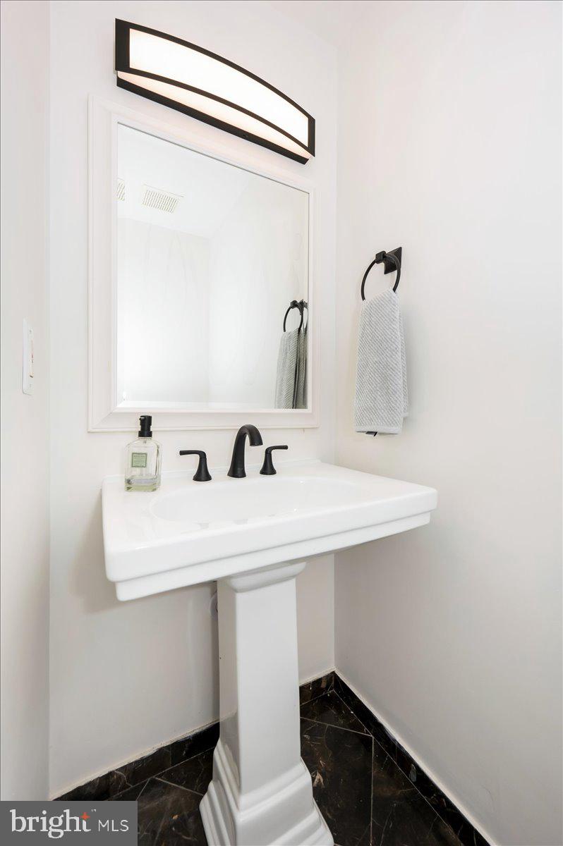 12144 Turnstone Court, Unit 87 Silver Spring, MD 20904 - Photo 30 of 56 a bathroom with a sink and a mirror