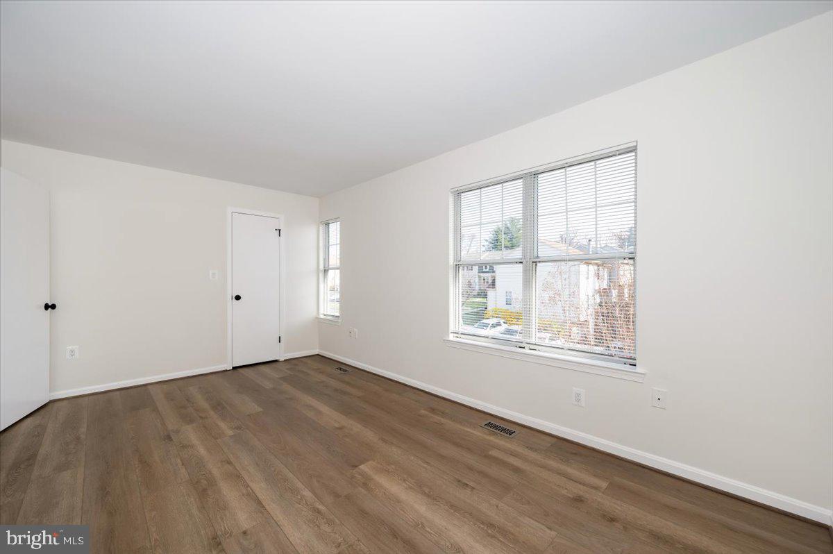 12144 Turnstone Court, Unit 87 Silver Spring, MD 20904 - Photo 31 of 56 an empty room with wooden floor and windows