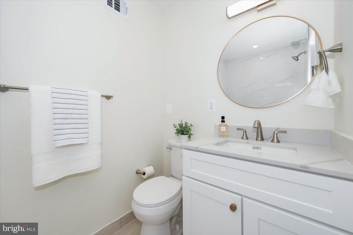 12144 Turnstone Court, Unit 87 Silver Spring, MD 20904 - Photo 35 of 56 a bathroom with a granite countertop sink and a mirror
