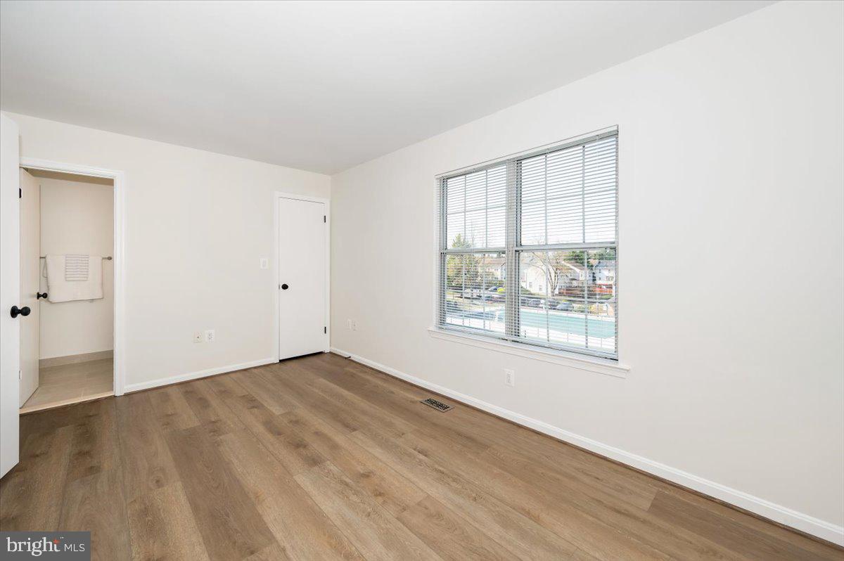 12144 Turnstone Court, Unit 87 Silver Spring, MD 20904 - Photo 39 of 56 an empty room with wooden floor and windows
