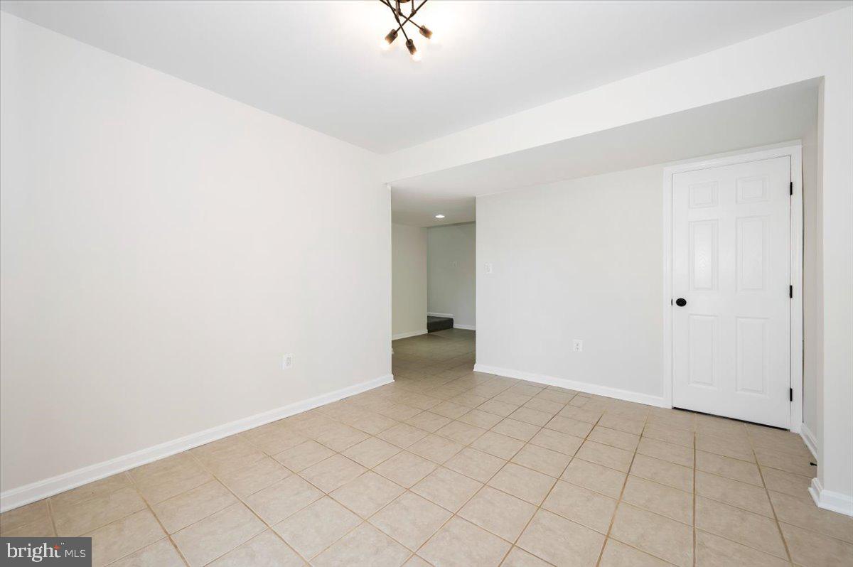 12144 Turnstone Court, Unit 87 Silver Spring, MD 20904 - Photo 42 of 56 an empty room with white walls and tiles