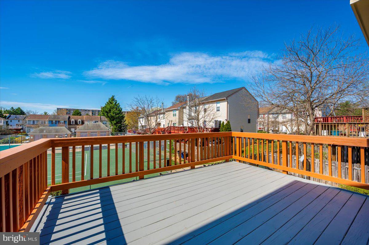 12144 Turnstone Court, Unit 87 Silver Spring, MD 20904 - Photo 48 of 56 a view of a deck with wooden floor and fence