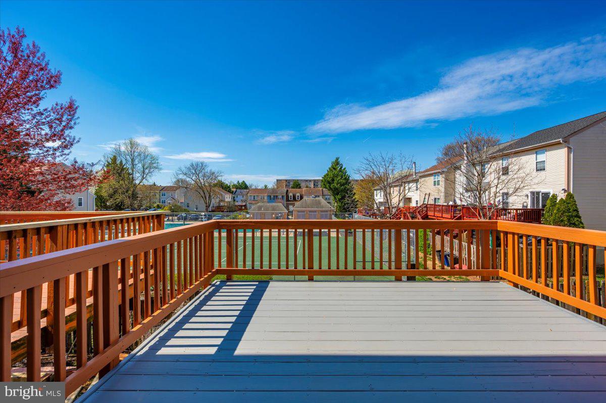 12144 Turnstone Court, Unit 87 Silver Spring, MD 20904 - Photo 50 of 56 a view of balcony with wooden floor and fence