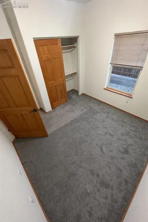 a view of an empty room with staircase